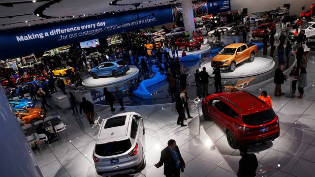 Reporters and guests visit the North American International Auto Show in Detroit