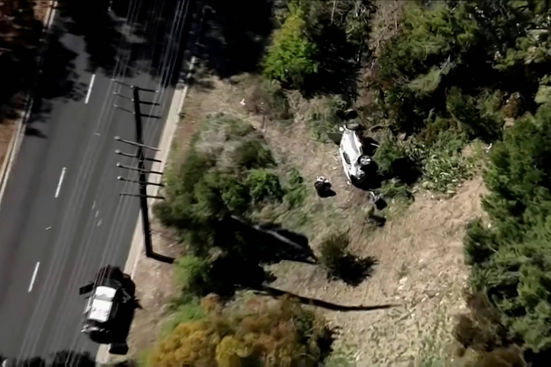 The vehicle of golfer Tiger Woods lies on its side after being involved in a single-vehicle accident in Los Angeles