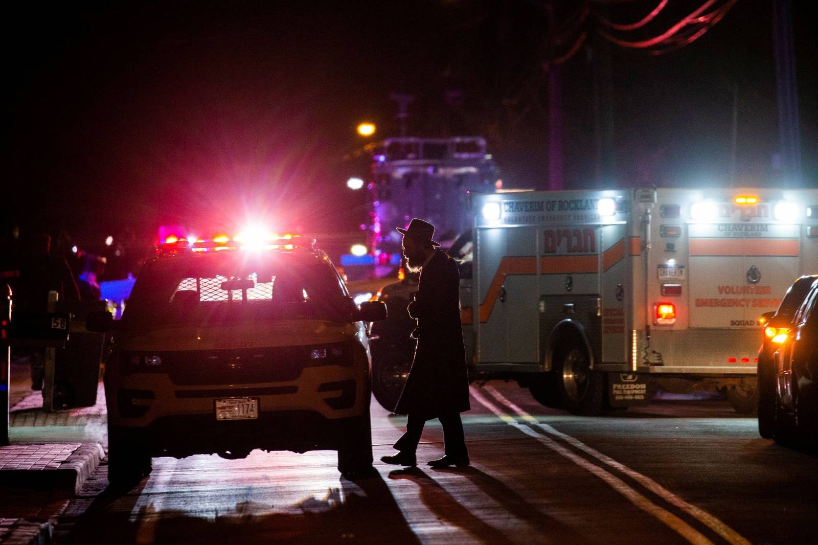 A Jewish man walks near the area where 5 people were stabbed at a Hasidic rabbi's home in Monsey, New York