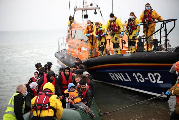 Migrants are brought ashore by a RNLI Lifeboat, after having crossed the channel, in Dungeness