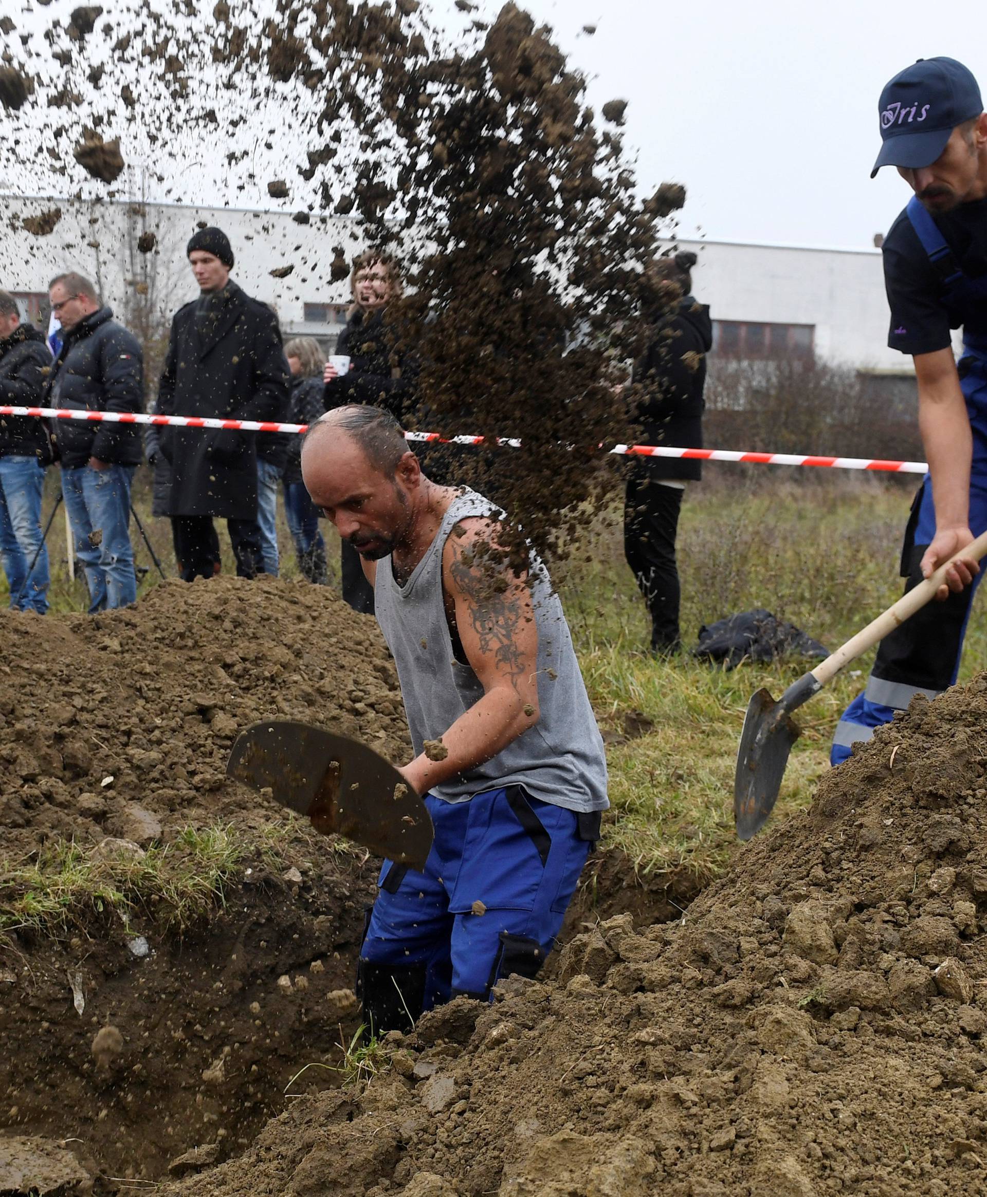 Gravediggers compete during a grave digging championship in Trencin, Slovakia