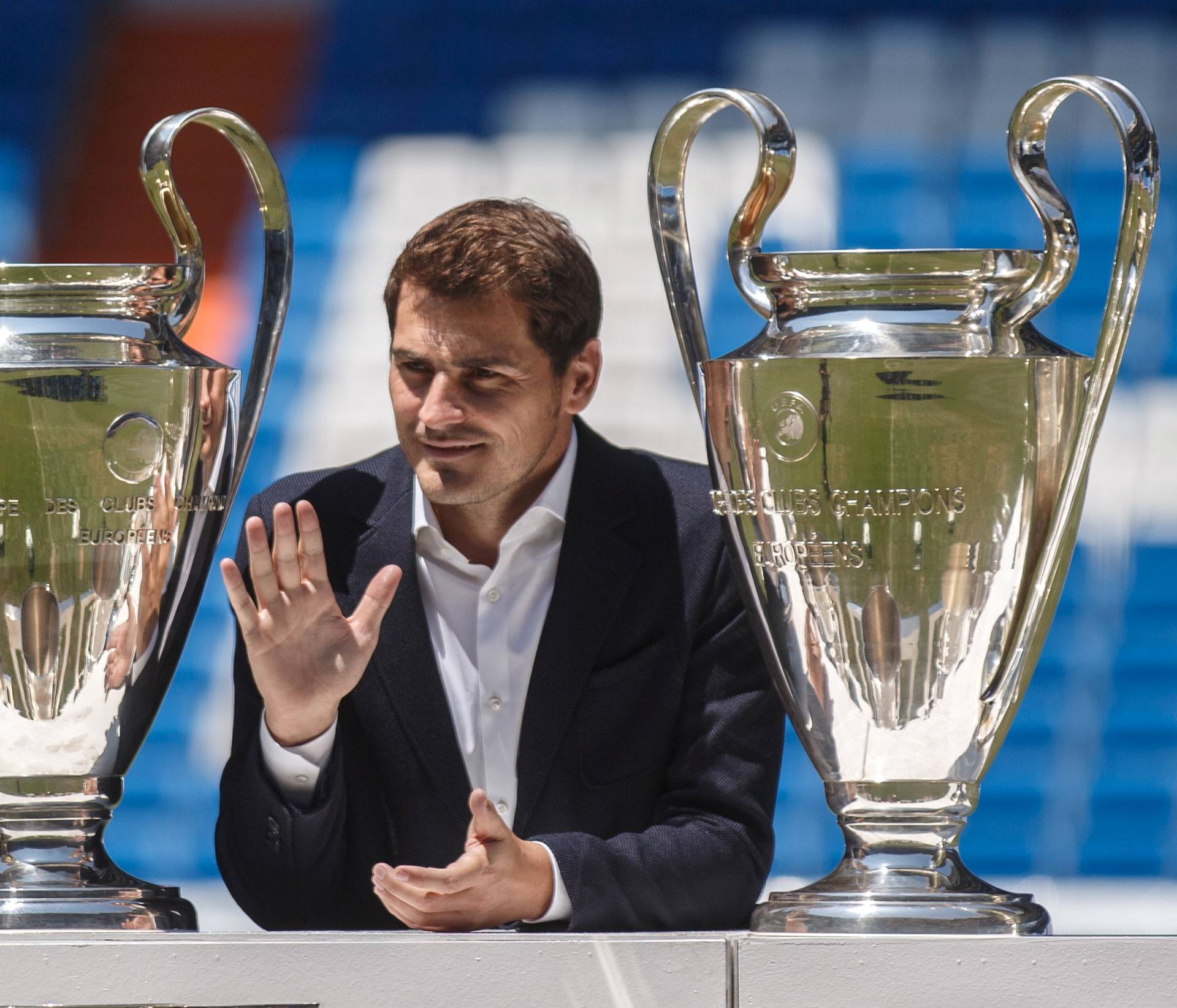 FILE PHOTO: Departing Real Madrid captain and goalkeeper Iker Casillas waves as he poses surrounded by trophies at an official send-off at the Bernabeu stadium in Madrid, Spain