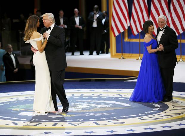 U.S. President Donald Trump and his wife first lady Melania Trump dance with Vice President Mike Pence and his wife Karen at the "Salute to Our Armed Forces" inaugural ball during inauguration festivites in Washington