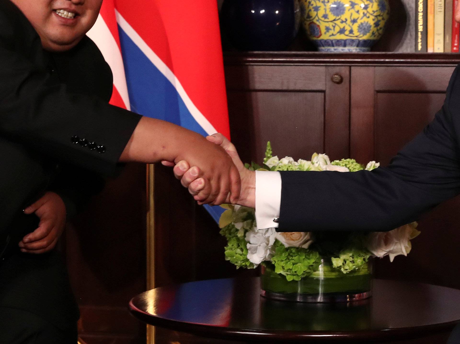 U.S. President Donald Trump shakes hands with North Korea's leader Kim Jong Un before their meeting in Singapore