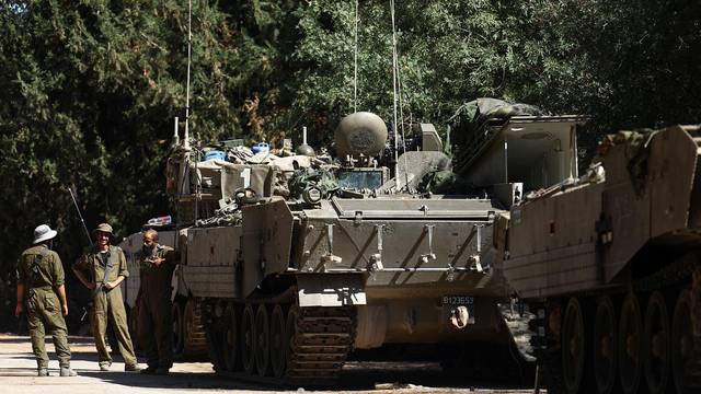 Israeli military vehicles deployed near Israel's border with Lebanon, in northern Israel