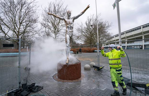 A worker cleans vandalized Zlatan Ibrahimovic statue in Malmo