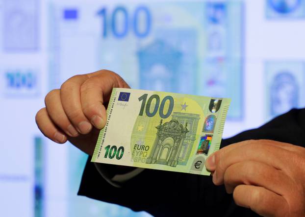 An Austrian central bank official displays a new 100 euro banknote in Vienna