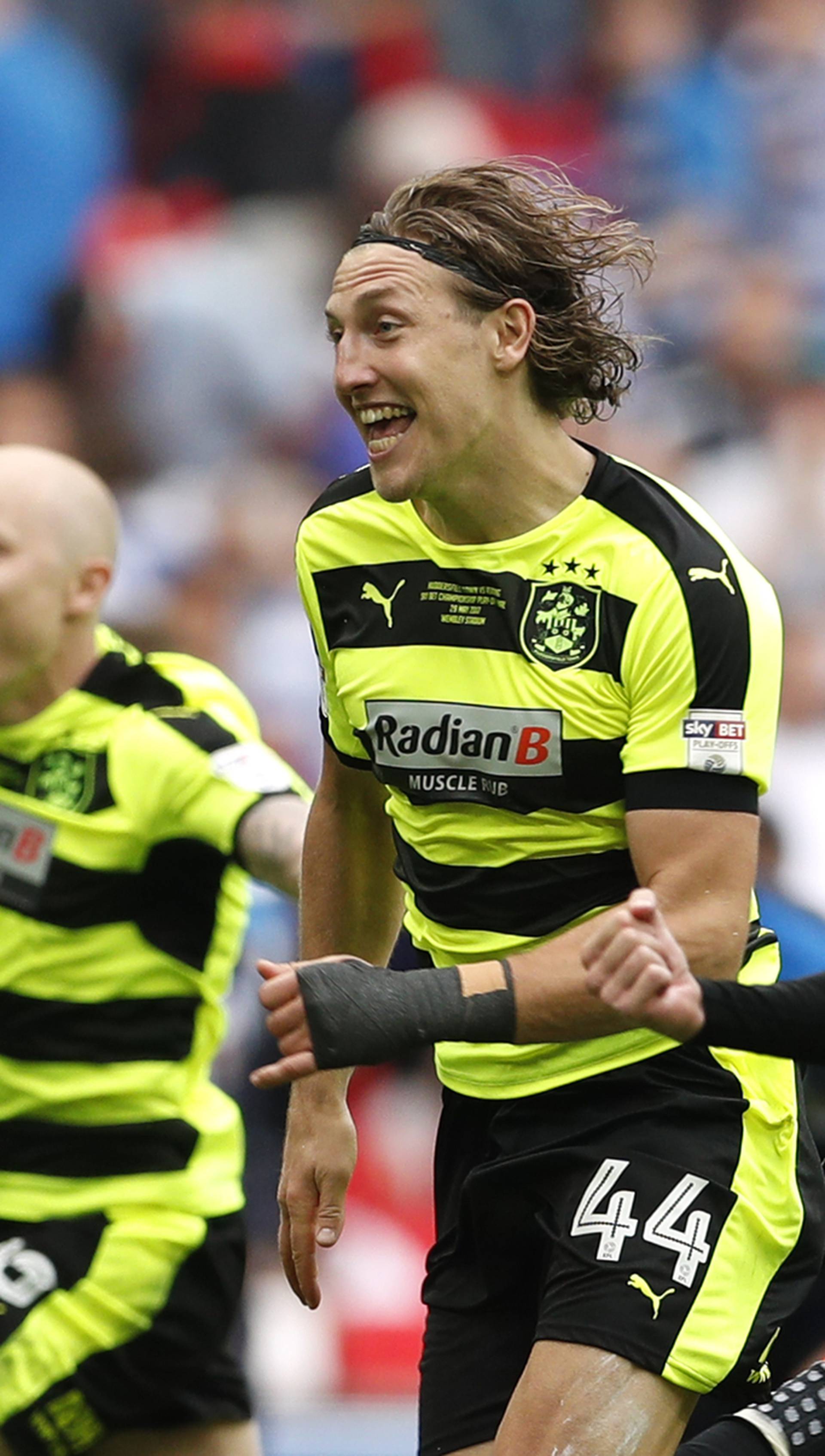 Huddersfield Town's Aaron Mooy, Michael Hefele and Martin Cranie celebrate after winning the Sky Bet Championship Play-Off Final and getting promoted to the Premier League