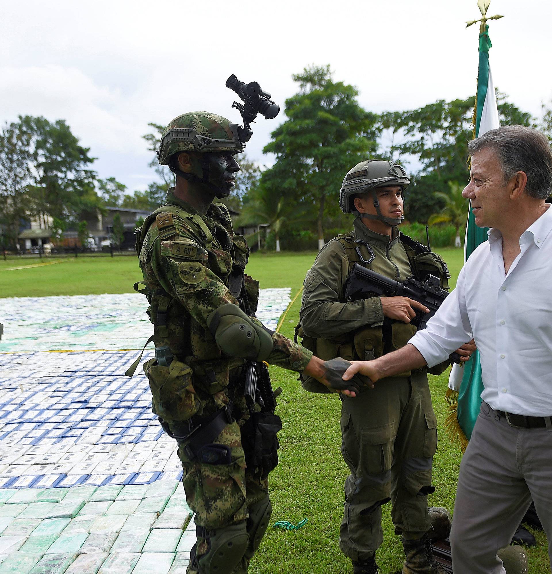 Colombia's President Juan Manuel Santos greets a soldier after the seizure of more than 12 tons of cocaine in Apartado