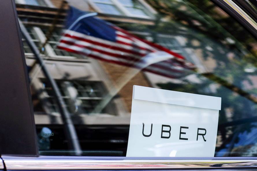 FILE PHOTO: An Uber sign is seen in a car in New York