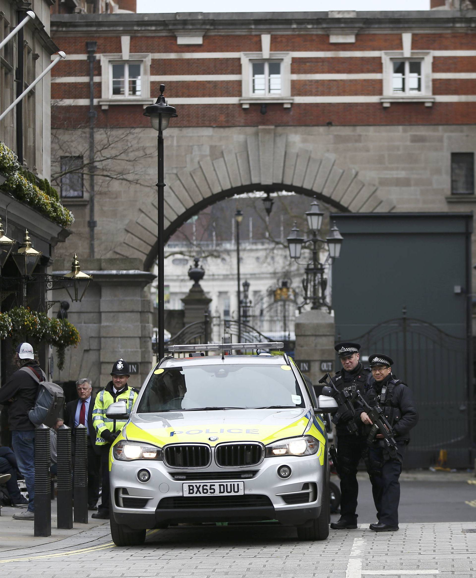 Armed police officers patrol Whitehall the morning after an attack in London