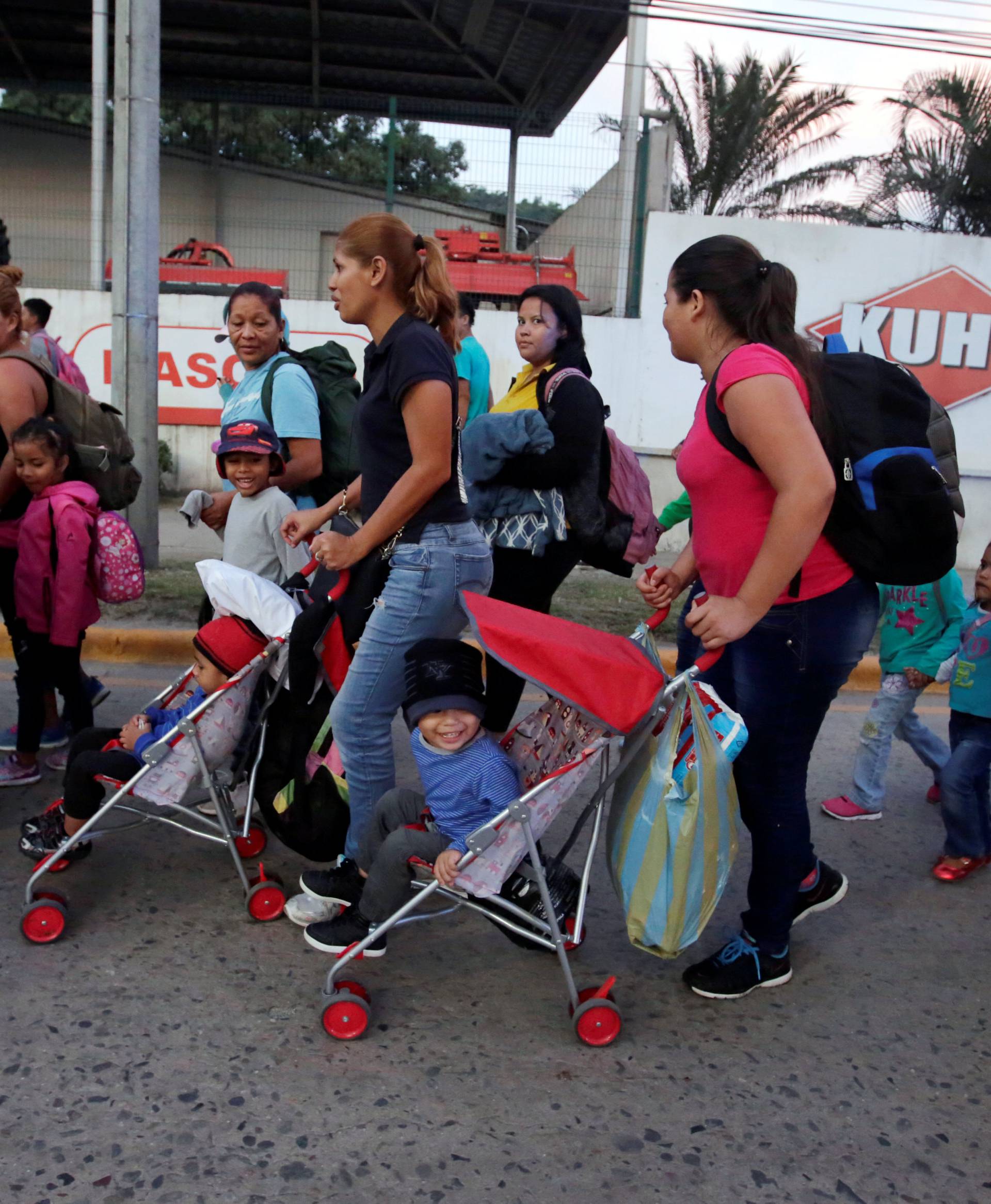 A large group of Hondurans fleeing poverty and violence, move in a caravan toward the United States, in San Pedro Sula