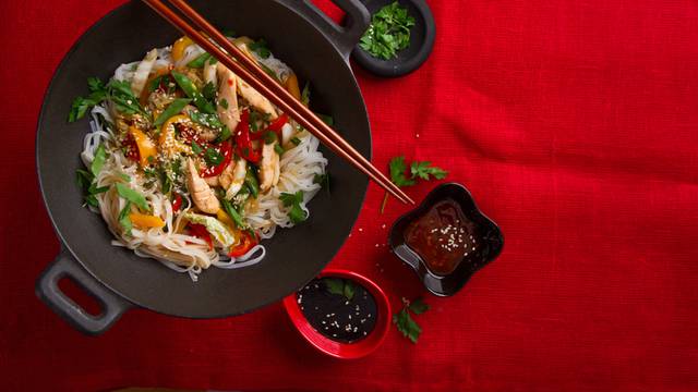 Asian rice noodles wok with chicken and vegetables