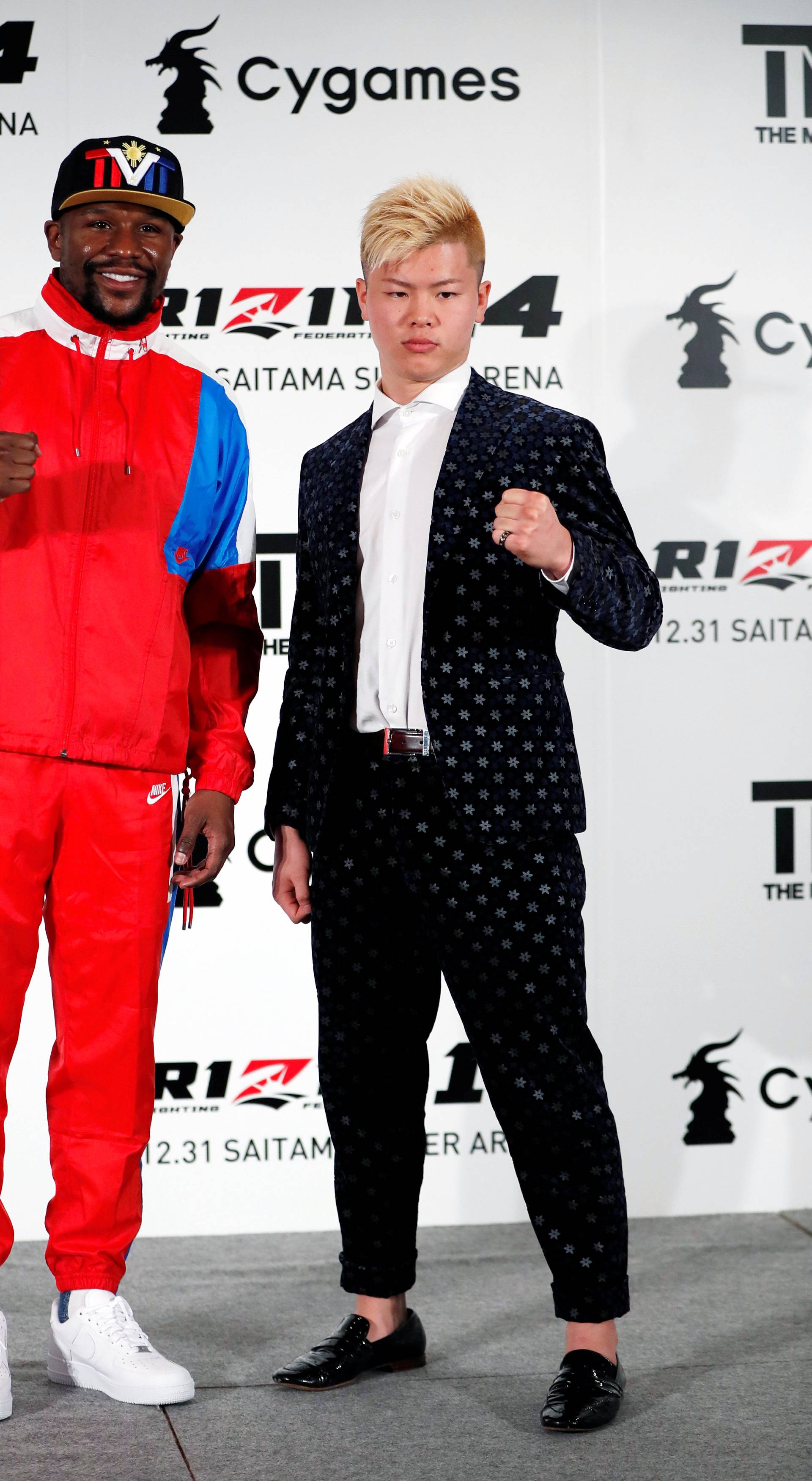 Undefeated boxer Floyd Mayweather Jr. of the U.S. poses for a photograph with his opponent Tenshin Nasukawa during a news conference in Tokyo