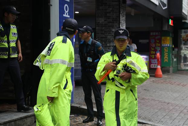 Police secure the area outside a night club after its upper floor collapsed in Gwangju