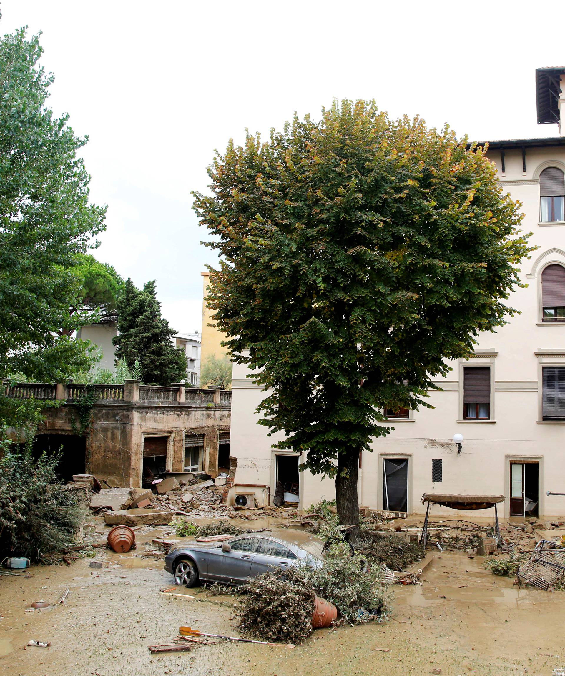 Damaged house and car are seen following floods in Livorno