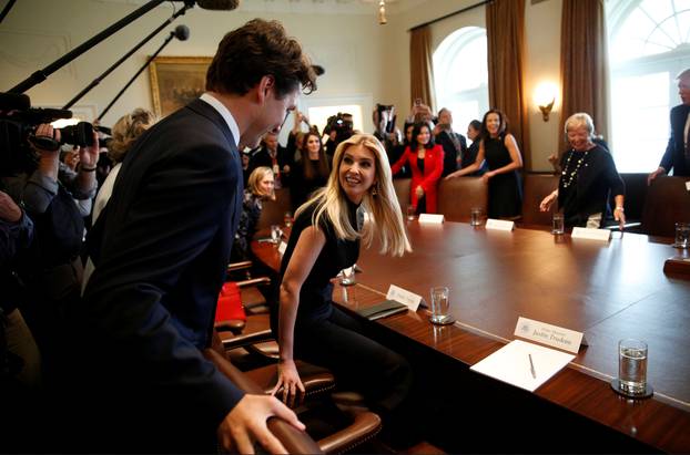 Ivanka Trump and Justin Trudeau take their seats at the White House in Washington