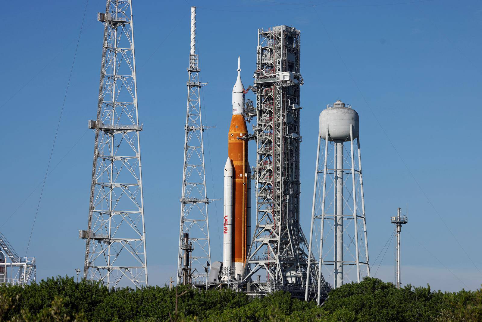 NASA’s next-generation moon rocket, the Space Launch System (SLS) rocket with its Orion crew capsule perched on top, stands on  launch pad 39B at Cape Canaveral,