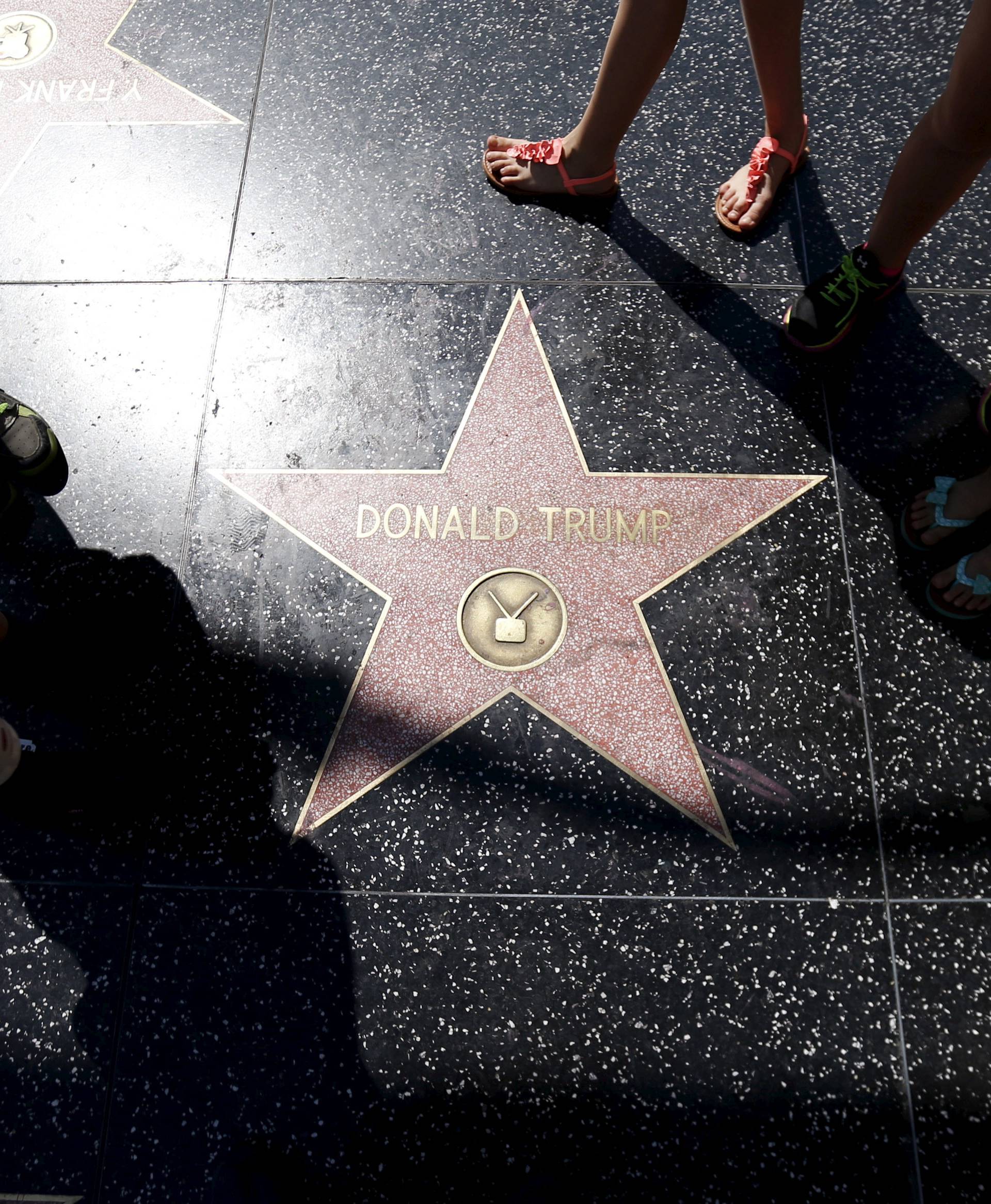 FILE PHOTO: People gather around the star of then U.S. Republican candidate Trump on the Hollywood Walk of Fame in Hollywood