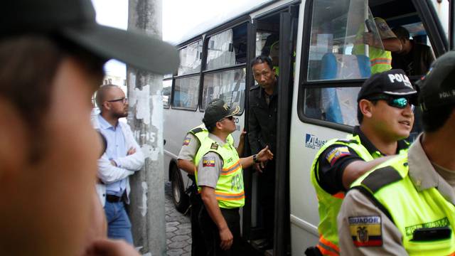 A Chinese crew member steps off a bus after being detained along with others for illegally fishing off the Galapagos Islands, in Puerto Baquerizo Moreno