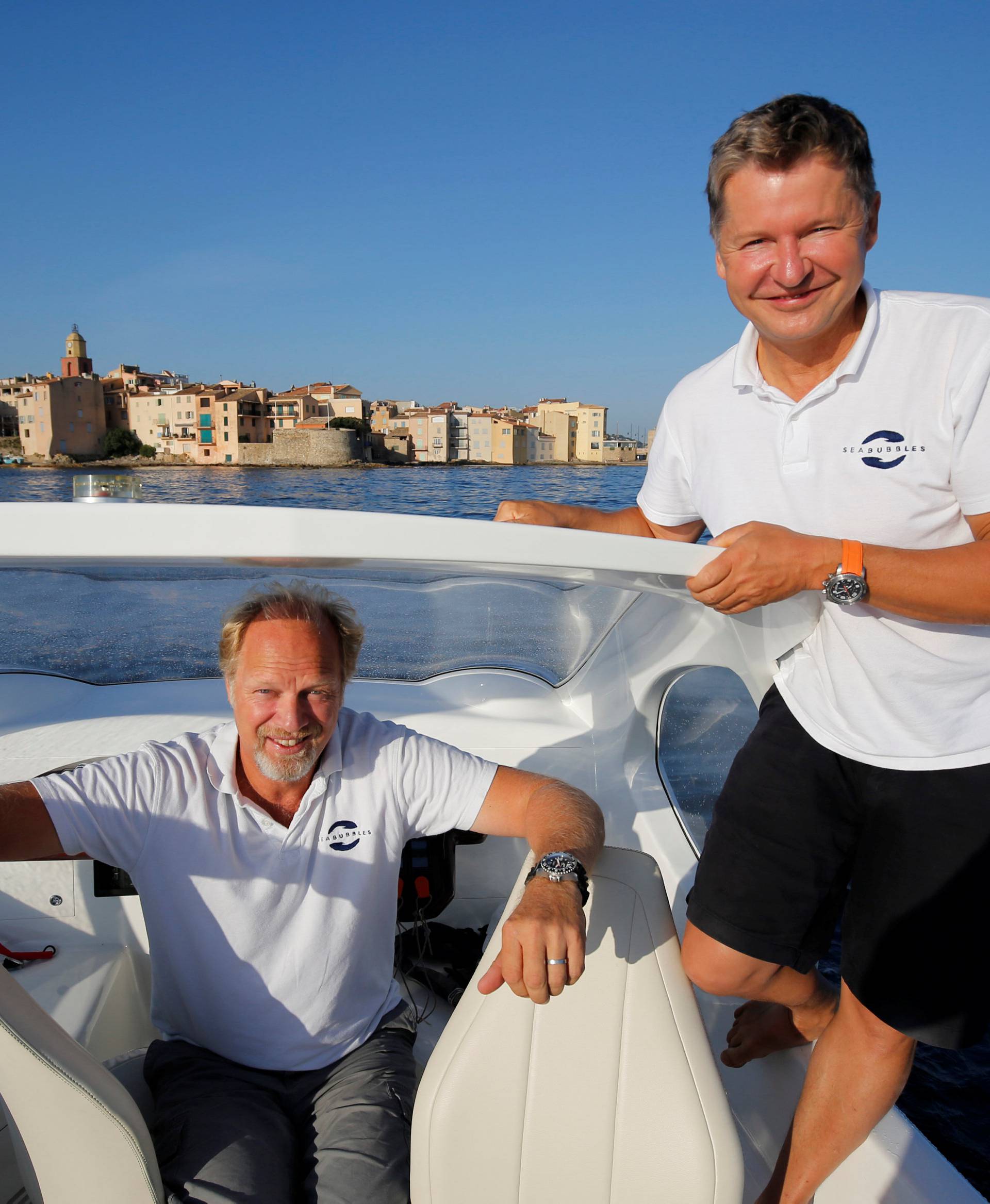 SeaBubbles' founder and president, Bringdal, and founder and VP, Thebault, pose aboard prototype of their water taxi in the harbour of Saint-Tropez