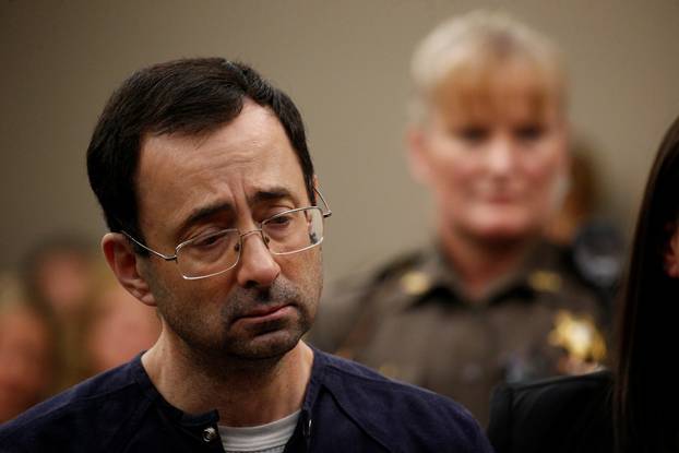 Larry Nassar, a former team USA Gymnastics doctor who pleaded guilty in November 2017 to sexual assault charges, stands during his sentencing hearing in Lansing