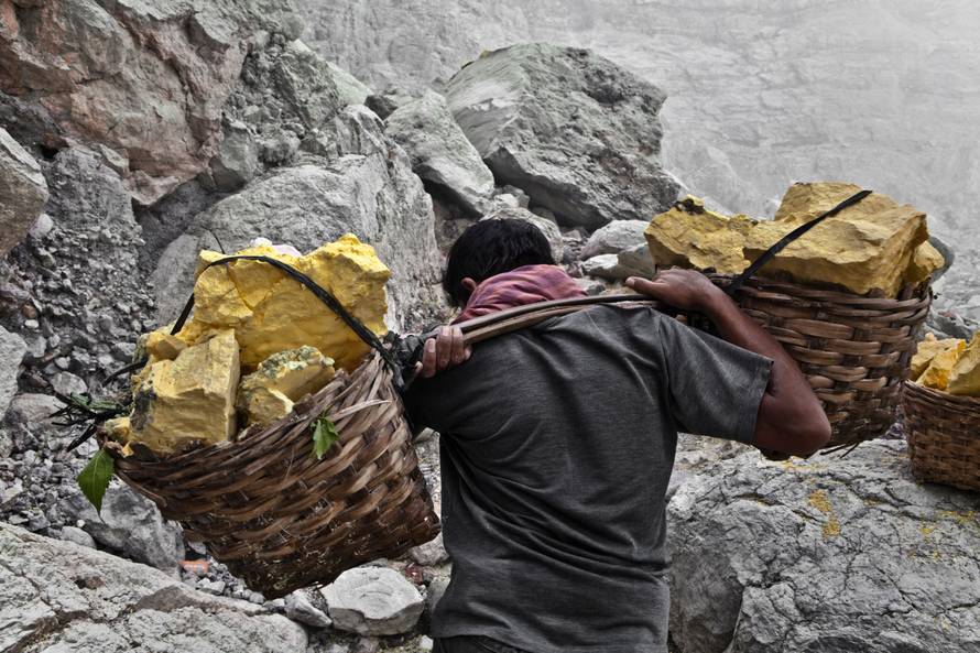 Sulfur workers at Kawa Ijen volcano in the sulfur mine, Kawa Ijen Plateau East Java Indonesia, Pacif