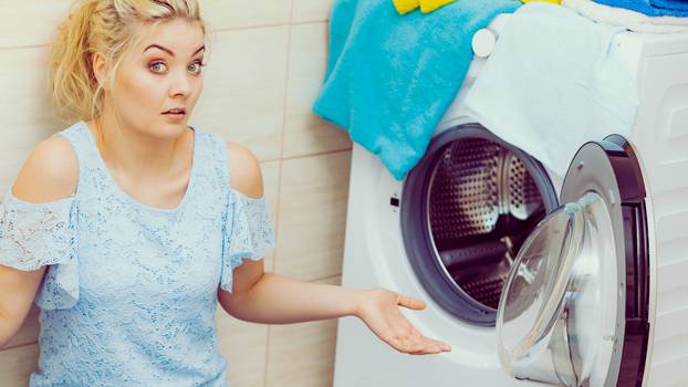 Sad girl with broken washing machine