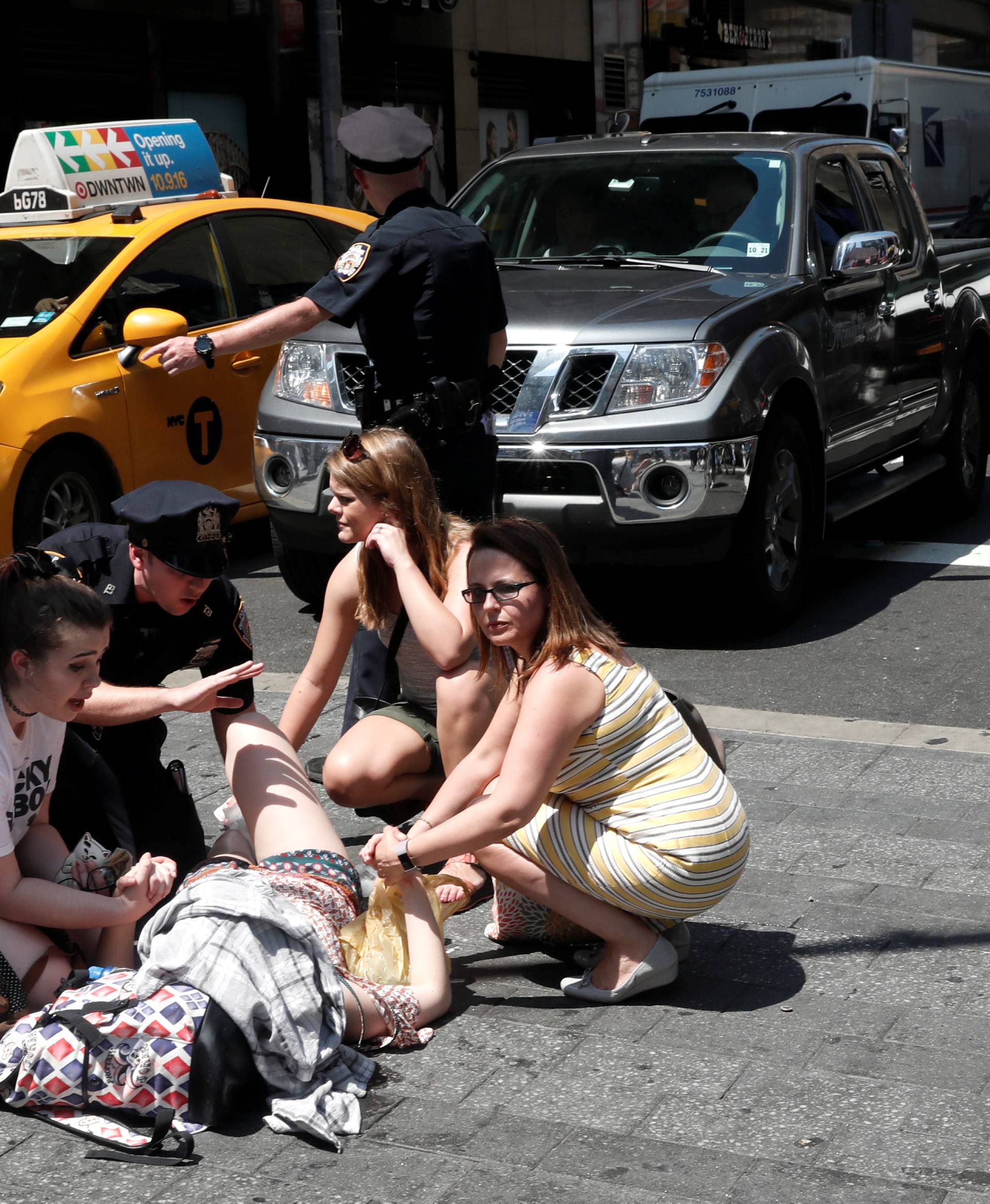 An injured woman is seen at a crosswalk in Times Square after a speeding vehicle struck pedestrians on the sidewalk in New York City