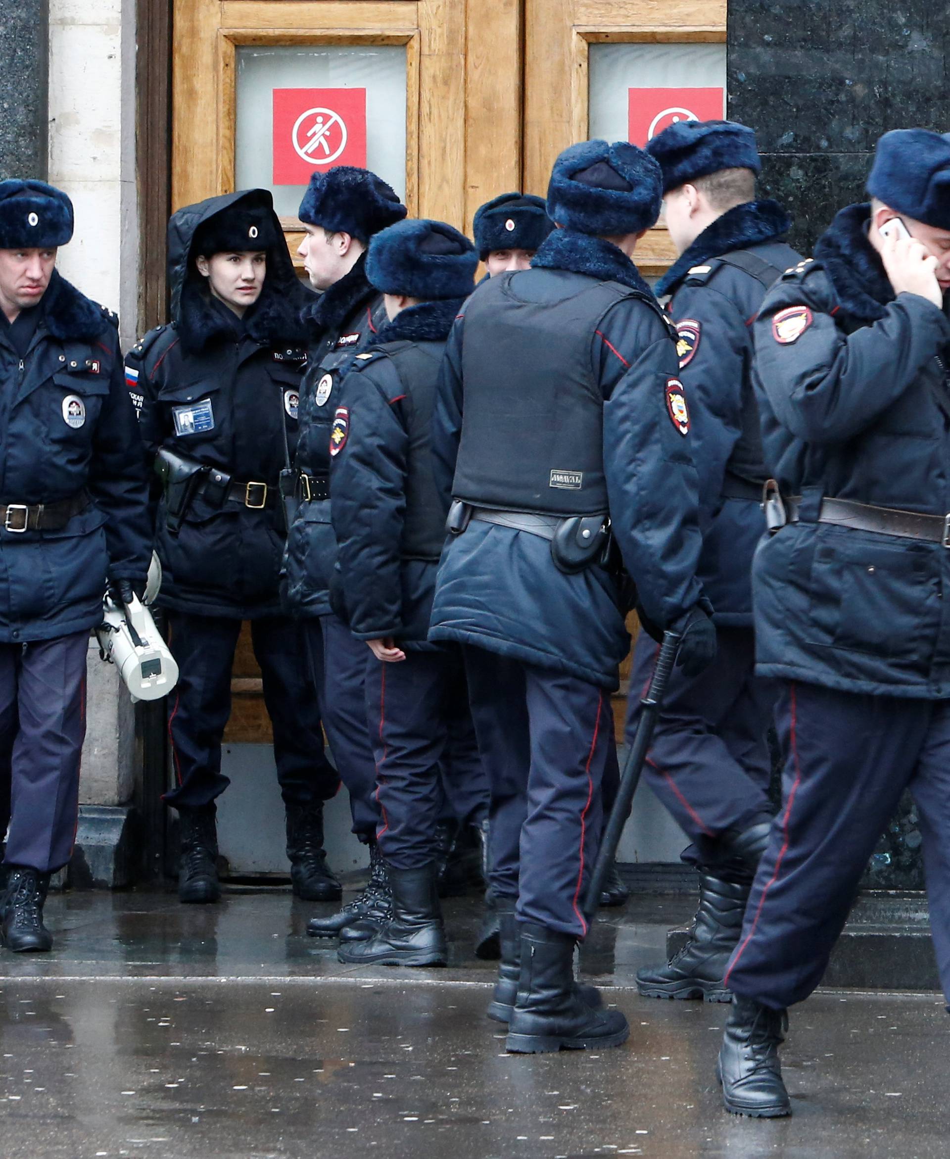 Police officers gather outside Ploschad Revolyutsii metro station in Moscow