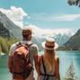 Travelers couple look at the mountain lake. Travel and active life concept with team. Adventure and travel in the mountains region in the Austria