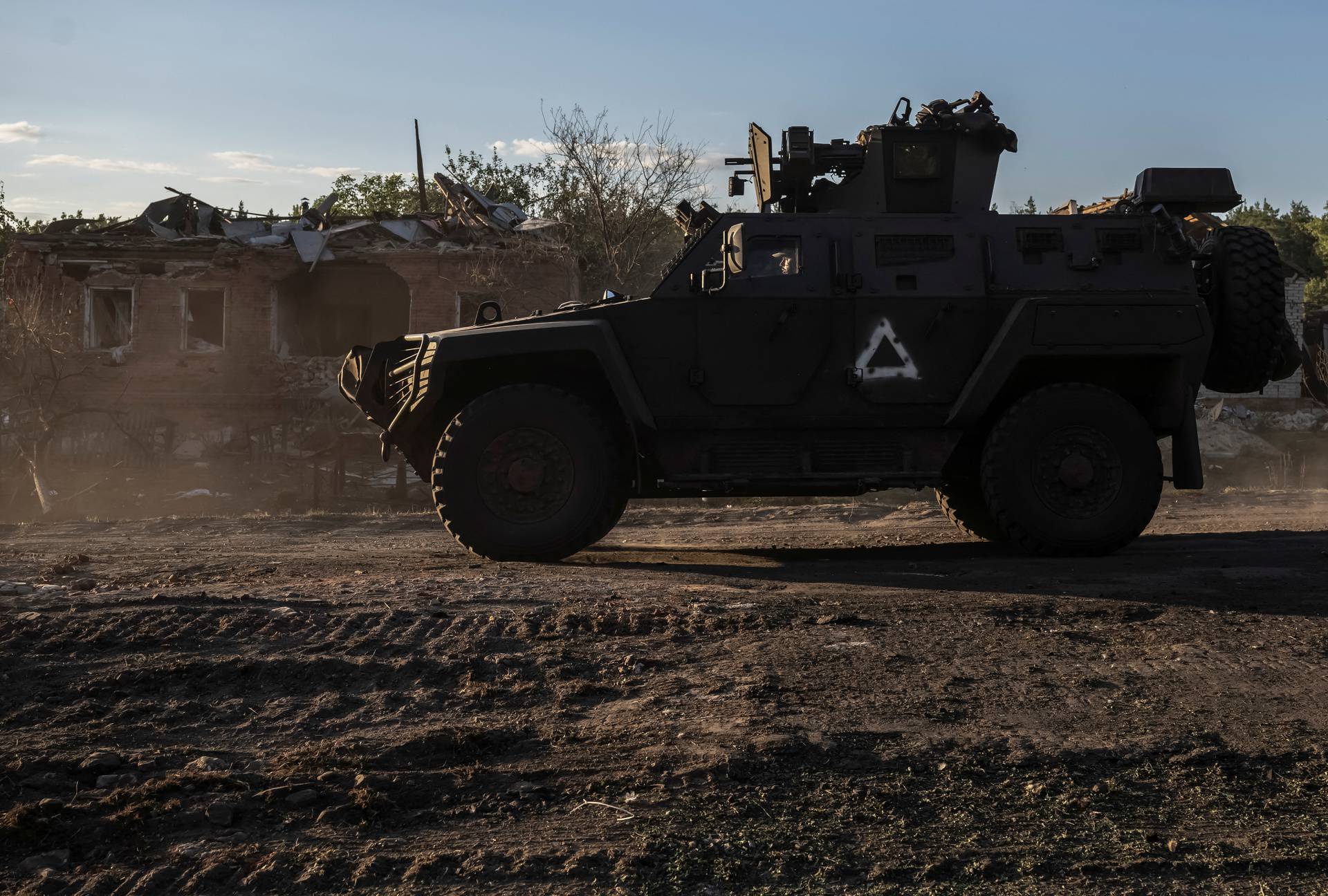 Ukrainian servicemen ride a military vehicle near the Russian border in Sumy region