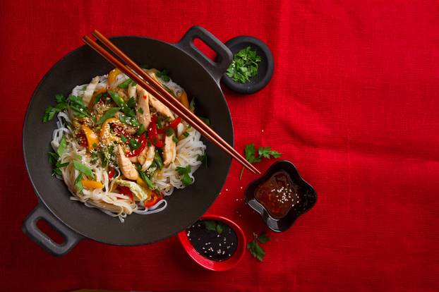 Asian rice noodles wok with chicken and vegetables