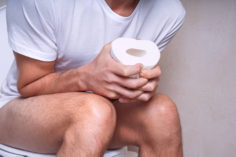 Man Sitting On The Toilet And Suffering From Constipation, Diarr