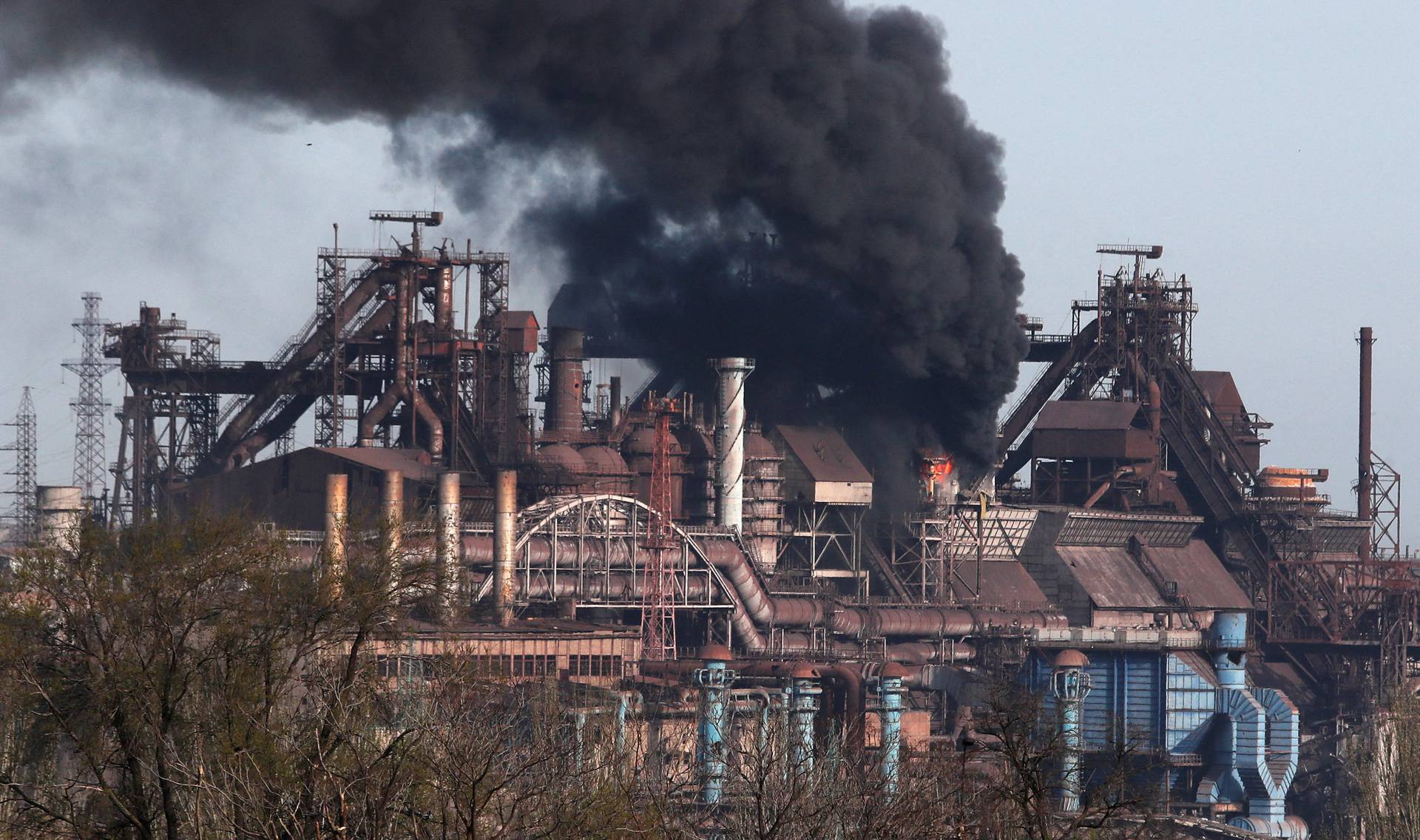 Smoke rises above a plant of Azovstal Iron and Steel Works in Mariupol