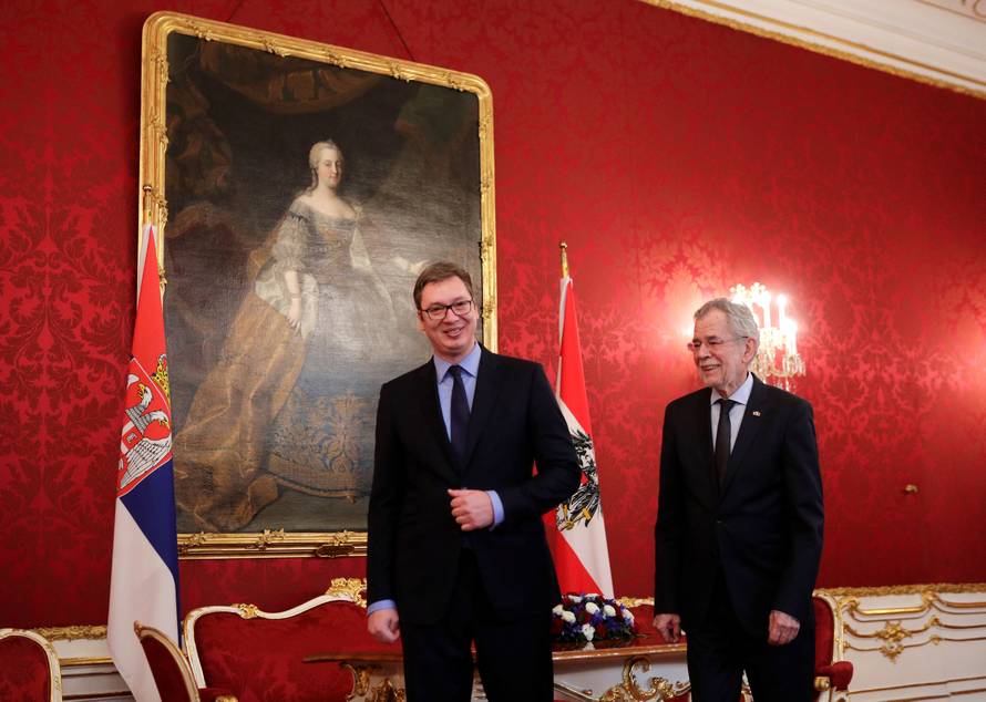 Serbia's President Vucic and Austria's President Van der Bellen walk by a portrait of former Empress Maria Theresa at the presidential office in Vienna