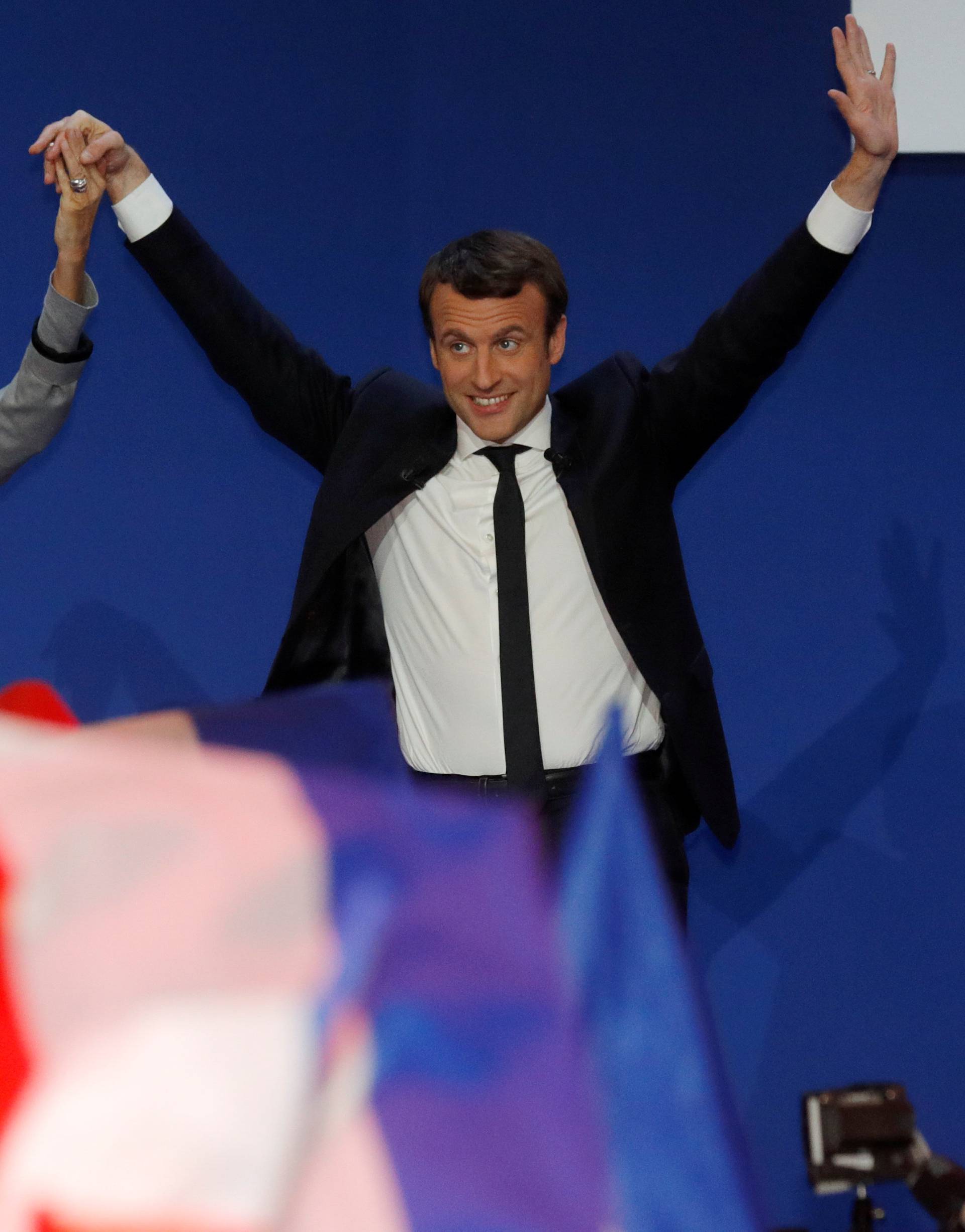 Emmanuel Macron, head of the political movement En Marche !, or Onwards !, and candidate for the 2017 French presidential election, arrives with his wife Brigitte Trogneux to deliver a speech at the Parc des Expositions hall in Paris