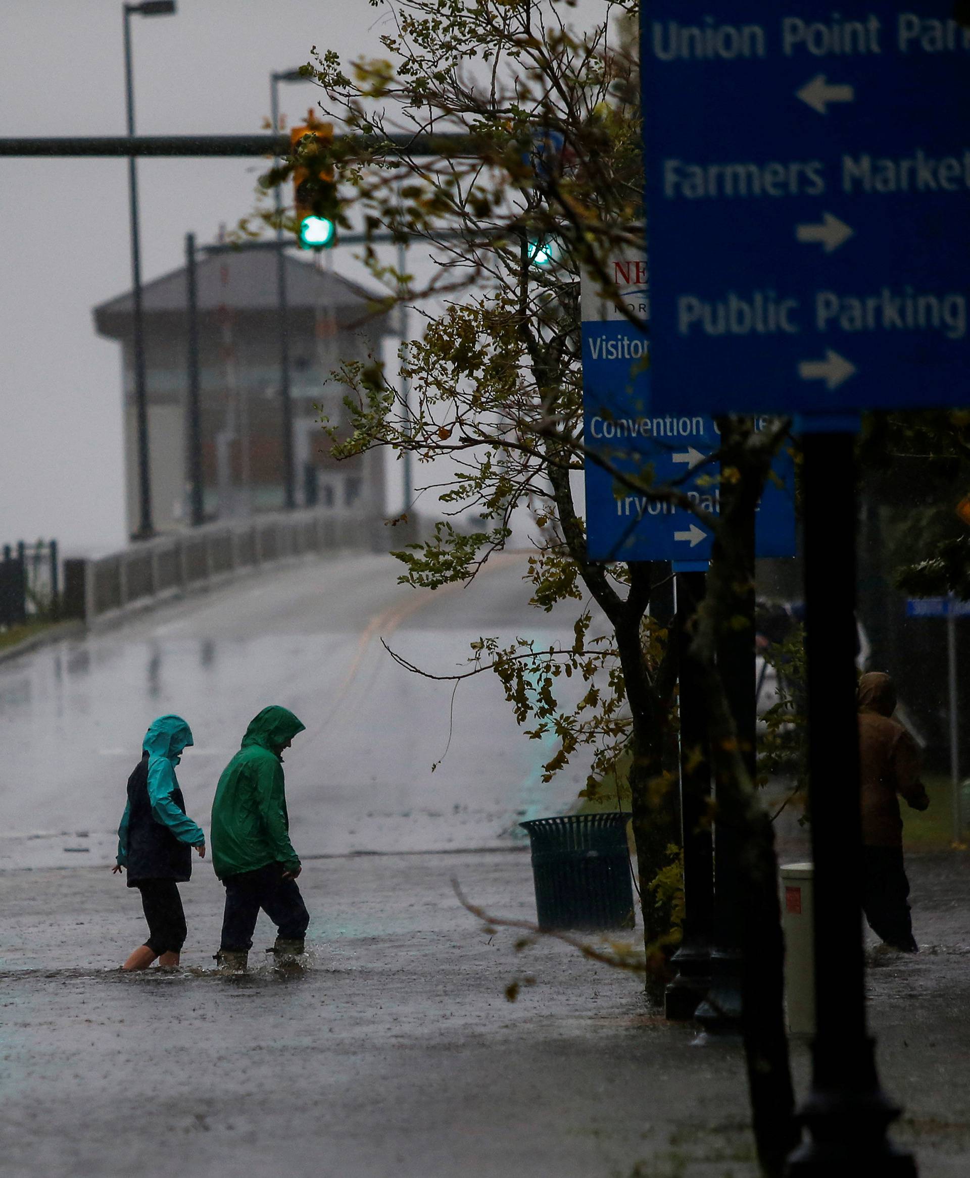 People walk on a local street as water from Neuse River starts flooding houses upon Hurricane Florence coming ashore in New Bern, North Carolina