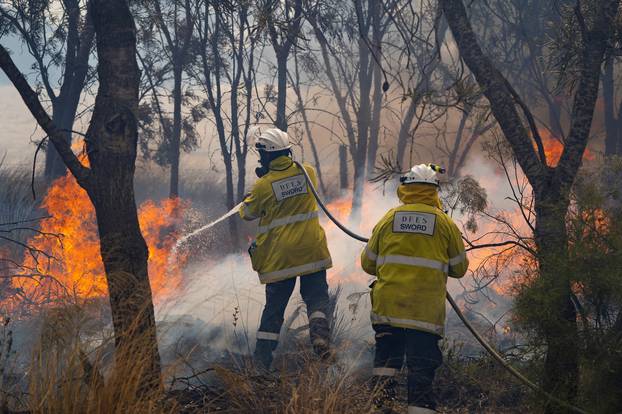 Firemen put out bushfire flames in Red Gully, Western Australia