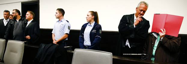 Defendants Wilfried and Angelika Wagener arrive for their trial at a courtroom in Paderborn