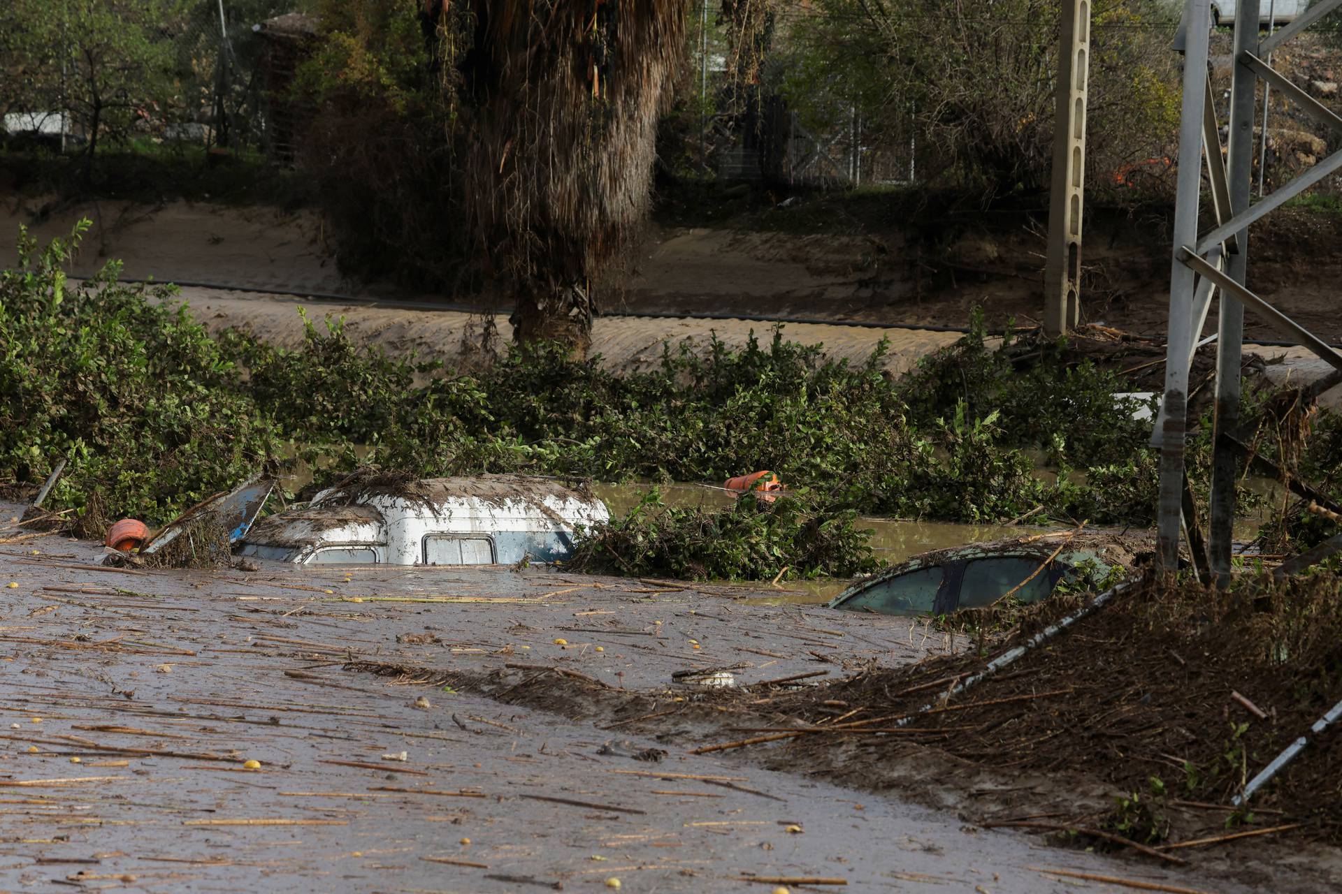 Cars sit submerged in a flooded area after heavy rains and floods in Alora