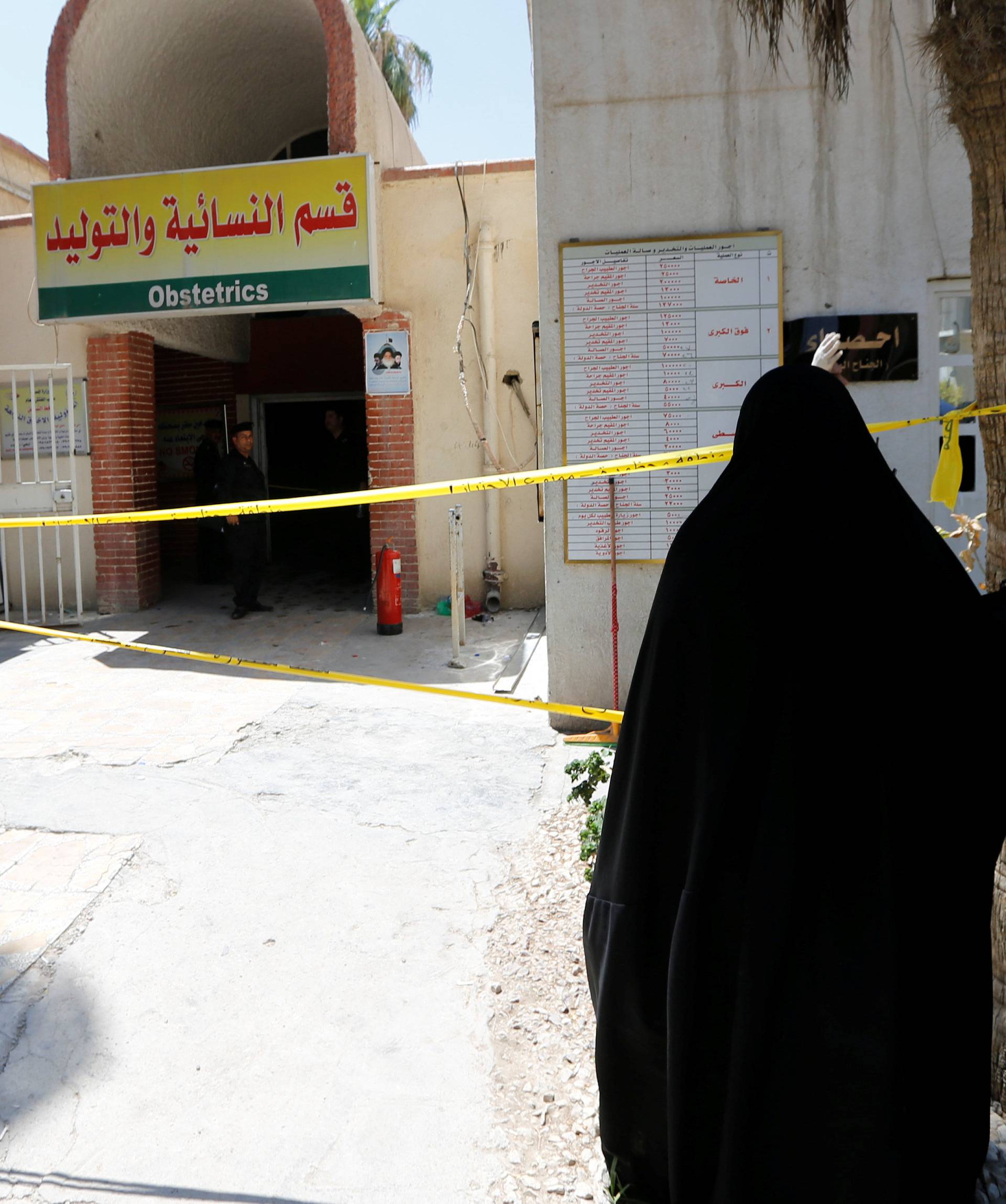 An Iraqi woman stands in front of a maternity ward after a fire broke out at Yarmouk hospital in Baghdad