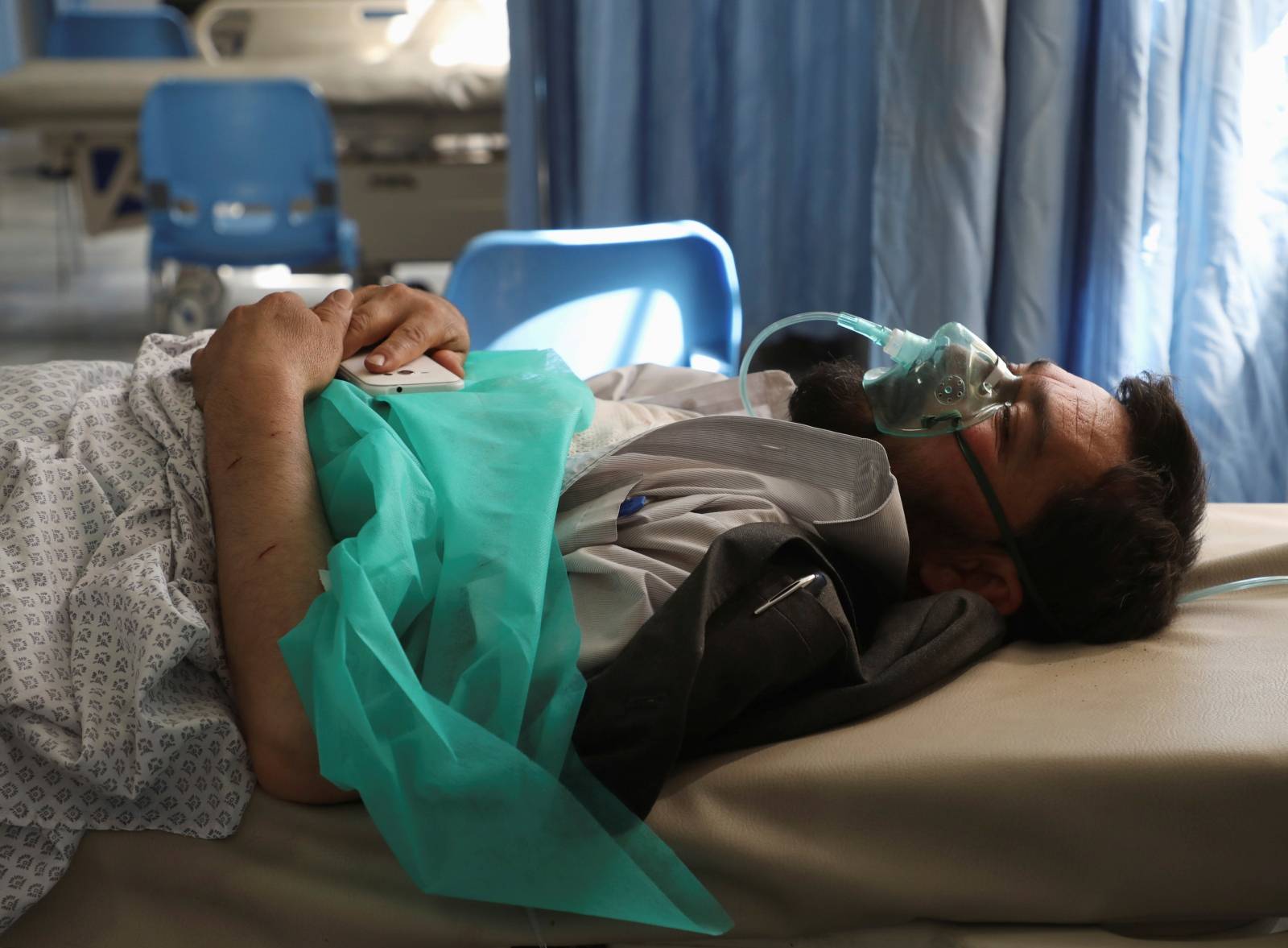 A wounded man receives treatment at a hospital after a blast in Kabul, Afghanistan