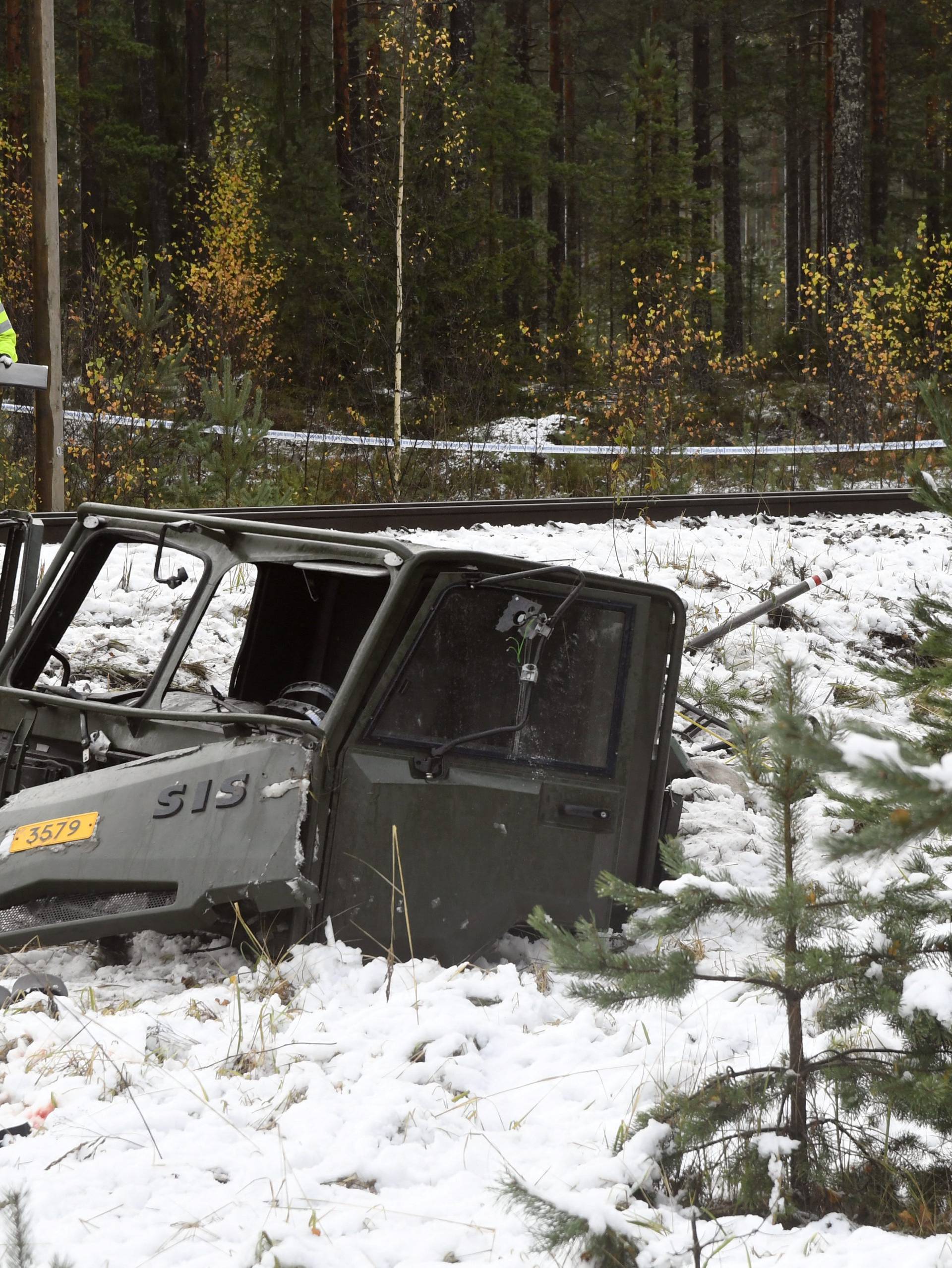 A military truck is pictured after a crash with a passenger train in Raasepori