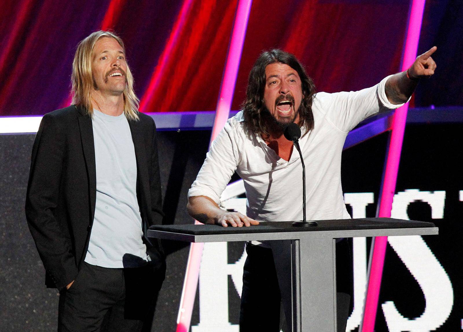 FILE PHOTO: Taylor Hawkins and Dave Grohl induct Rush at the 2013 Rock and Roll Hall of Fame induction ceremony in Los Angeles