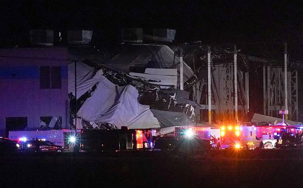 Emergency vehicles surround the site of an Amazon distribution warehouse with a collapsed roof in Edwardsville