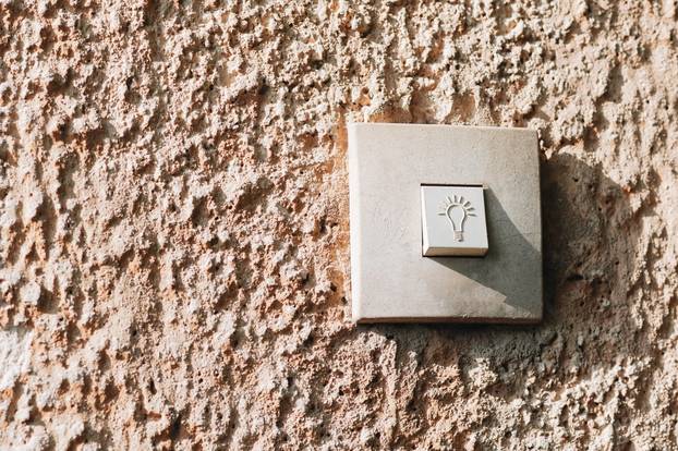 Lightbulb,Icon,Switch,On,Rough,Stucco,Wall