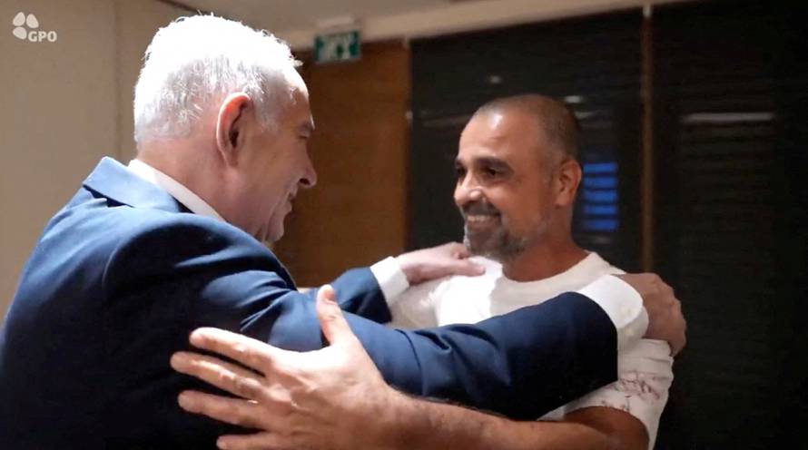 Israeli Prime Minister Benjamin Netanyahu meets Yaniv Hayun, a passenger on the FlyDubai flight