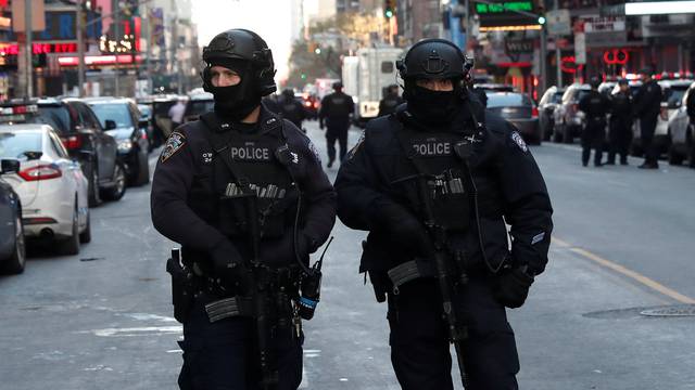 Police officers stand on a closed West 42nd Street near the New York Port Authority Bus Terminal after reports of an explosion in New York City