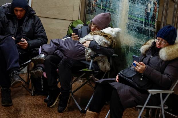 People take shelter inside a metro station during a Russian military strike in Kyiv